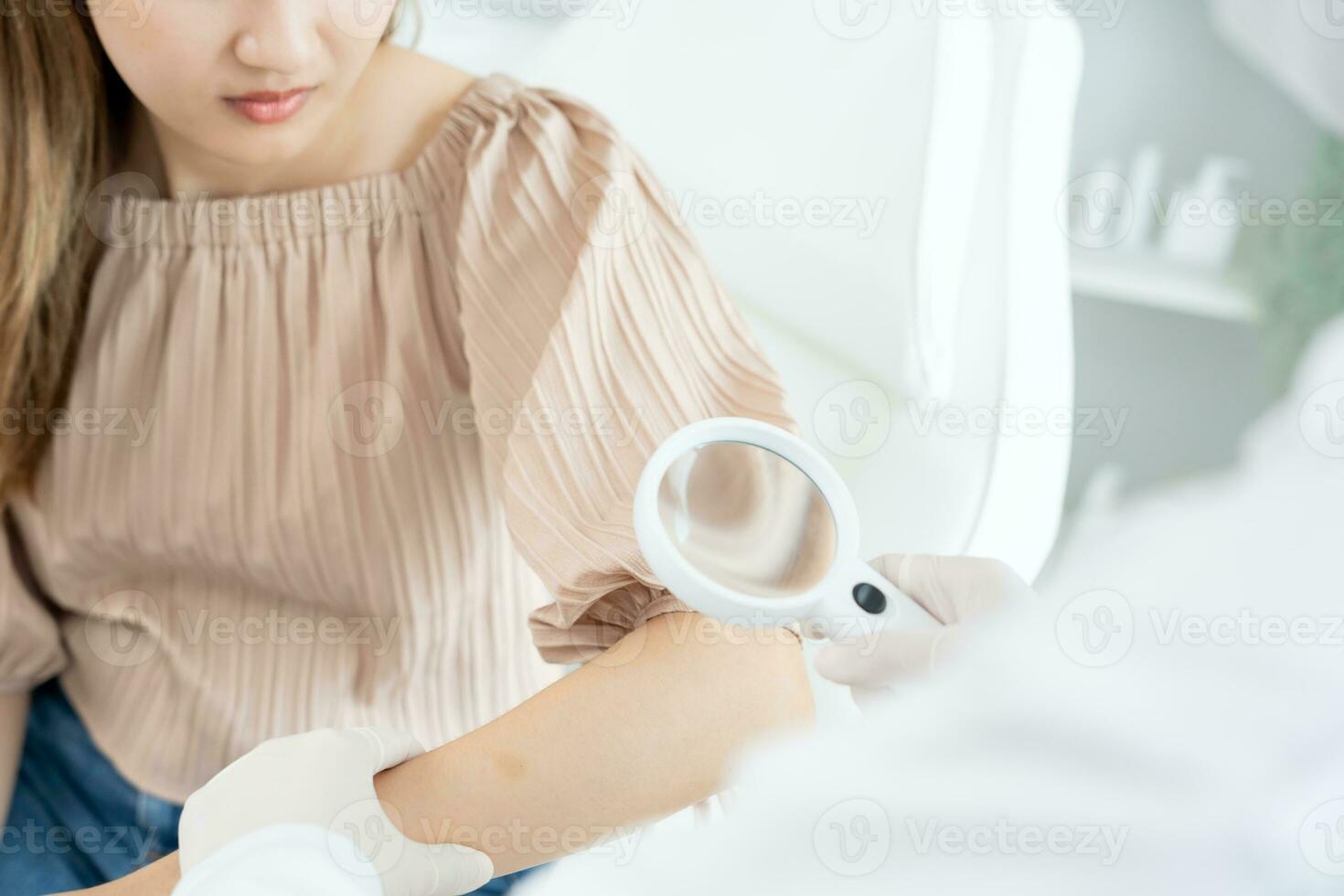 skin problem and beauty of asian girl. Dermatologist use magnifying glass look itchy skin from skin allergic, steroid allergy, sensitive skin, chemical allergy, rash, insect bites, Dermatitis. photo