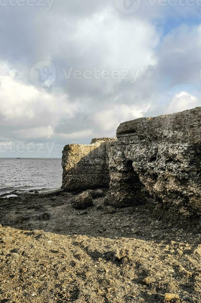 The bottom of the river after low tide, flooded remains of houses and bridges photo