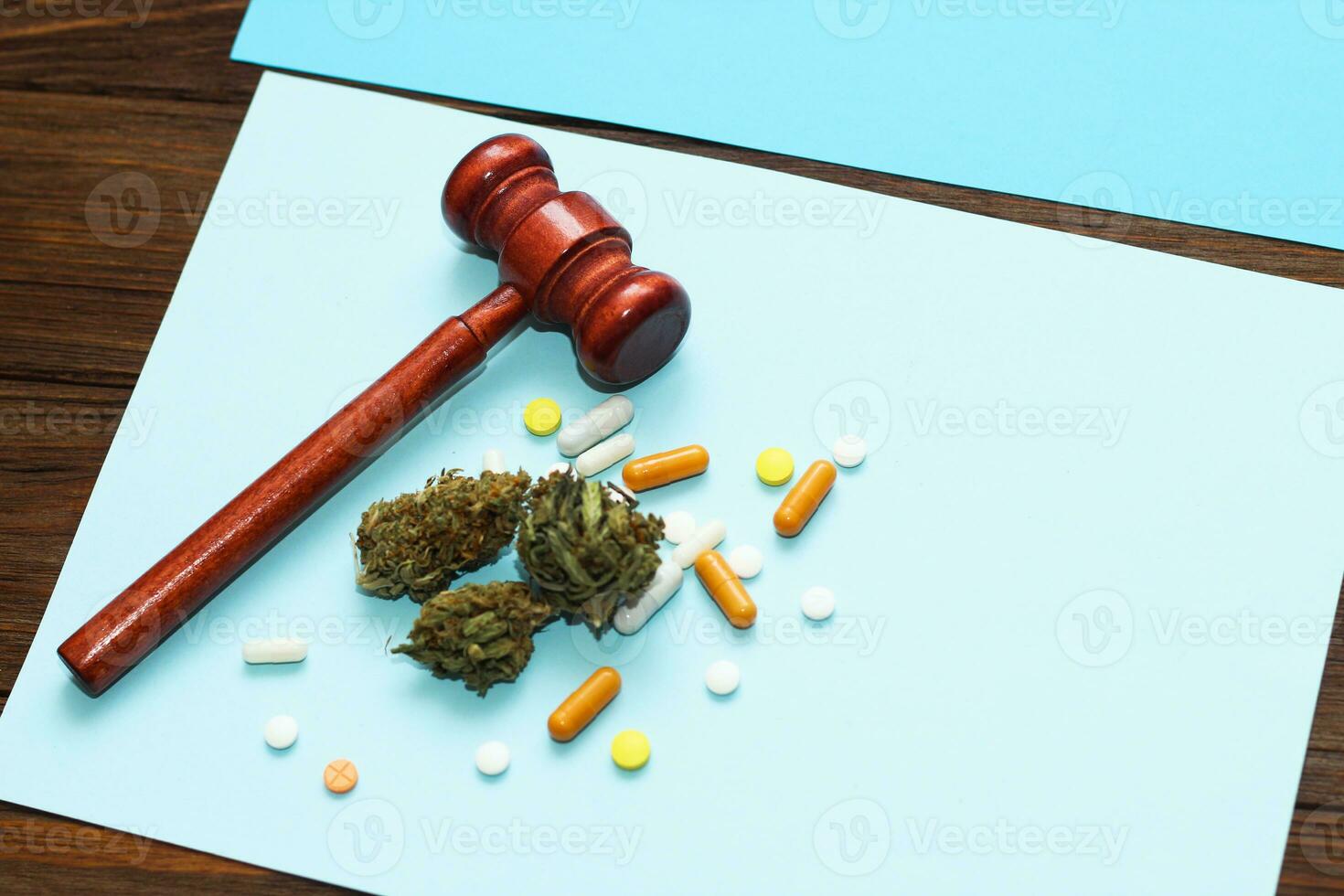 Medical marijuana, inflorescences of shinki herb plant with judge's gavel and pills photo