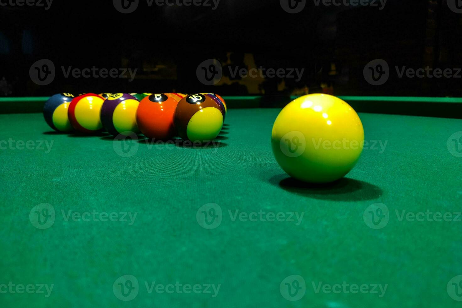Pool cues close-up on a green table for playing photo