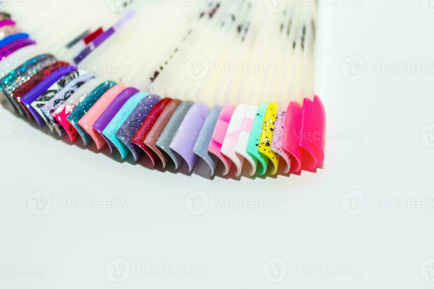 Palette of nail designs, testers of multicolored polishes on flat nails photo