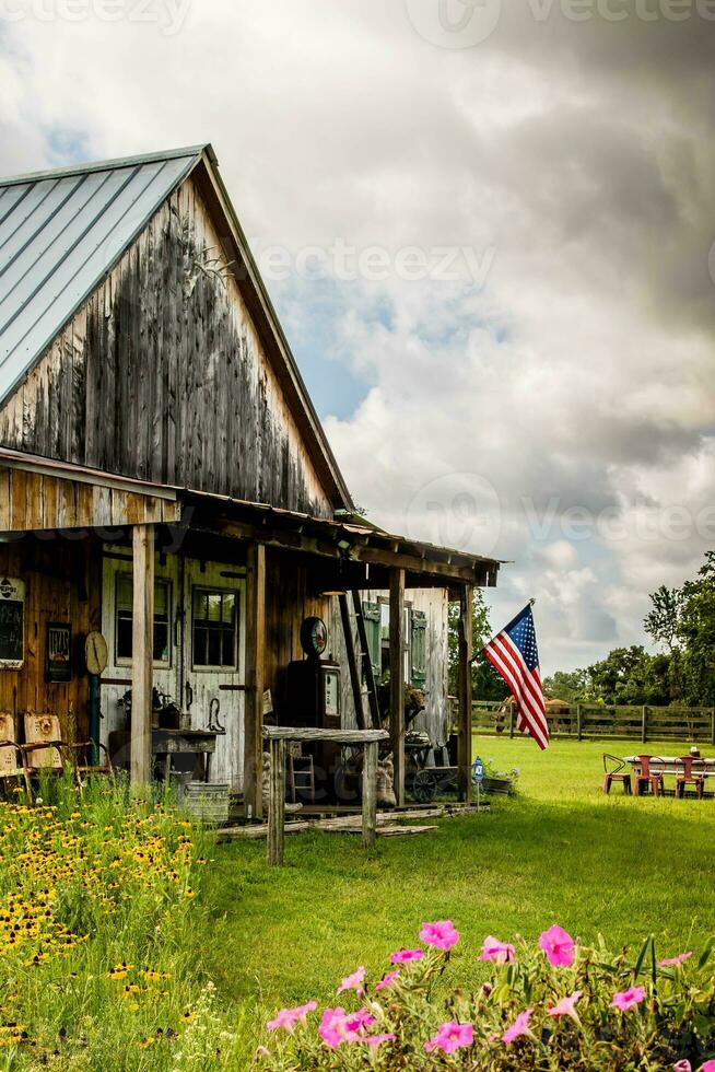 Abandoned old wooden house with American flag in the foreground photo