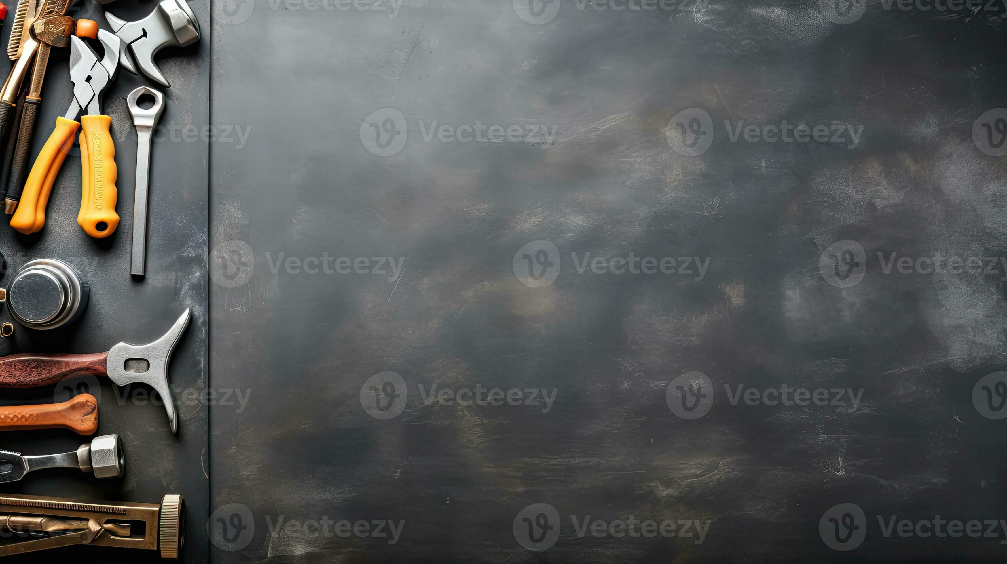 Top view of construction tools on blackboard background with copy space