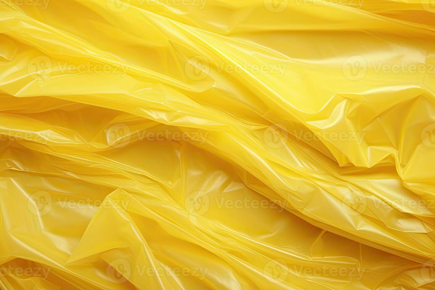 bright yellow plastic wrap overlay backdrop. crumpled and draped textured cellophane material photo
