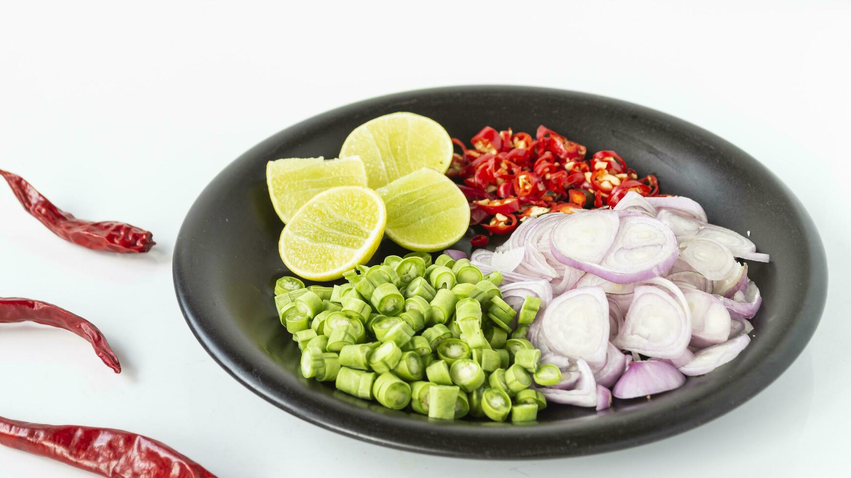 a bowl of vegetables with chilli and onions photo