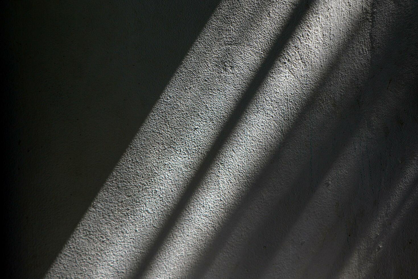 Light and shadow overlaid on old and rough plaster walls. Blur the focus to soften it. photo