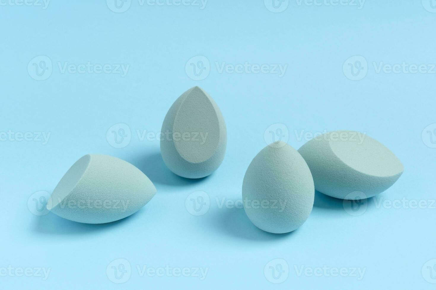 Blue cosmetic makeup sponge on a minimal background. Tool for applying foundation cream. Nobody photo