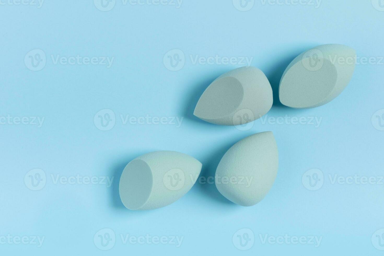 Blue cosmetic makeup sponge on a minimal background. Tool for applying foundation cream. Nobody photo