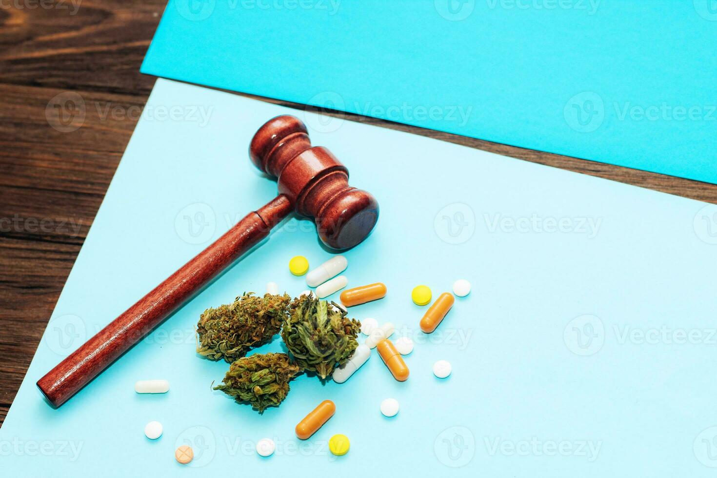 Medical marijuana, inflorescences of shinki herb plant with judge's gavel and pills photo