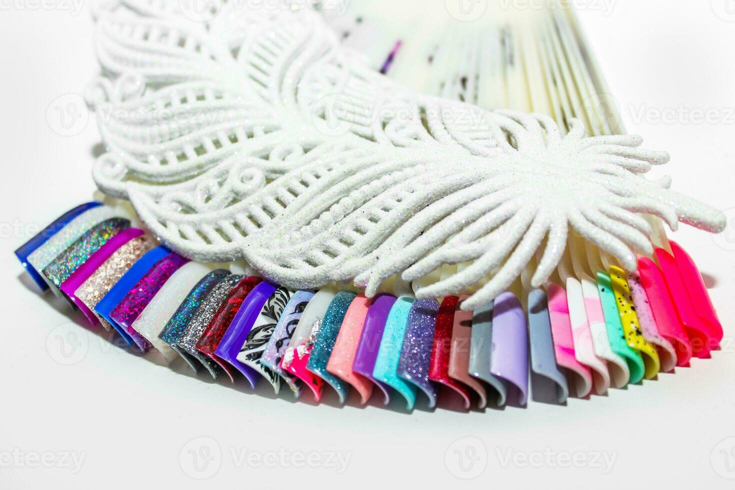 Palette of nail designs, testers of multicolored polishes on flat nails photo