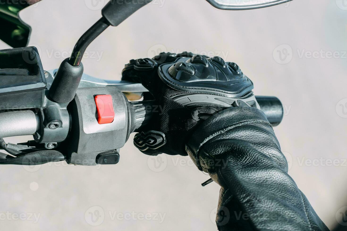 Protective moto gloves, safety gear close-up on brake handle photo