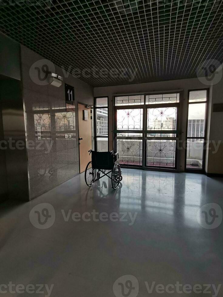 The wheelchair in the middle of an empty corridor in the hospital photo