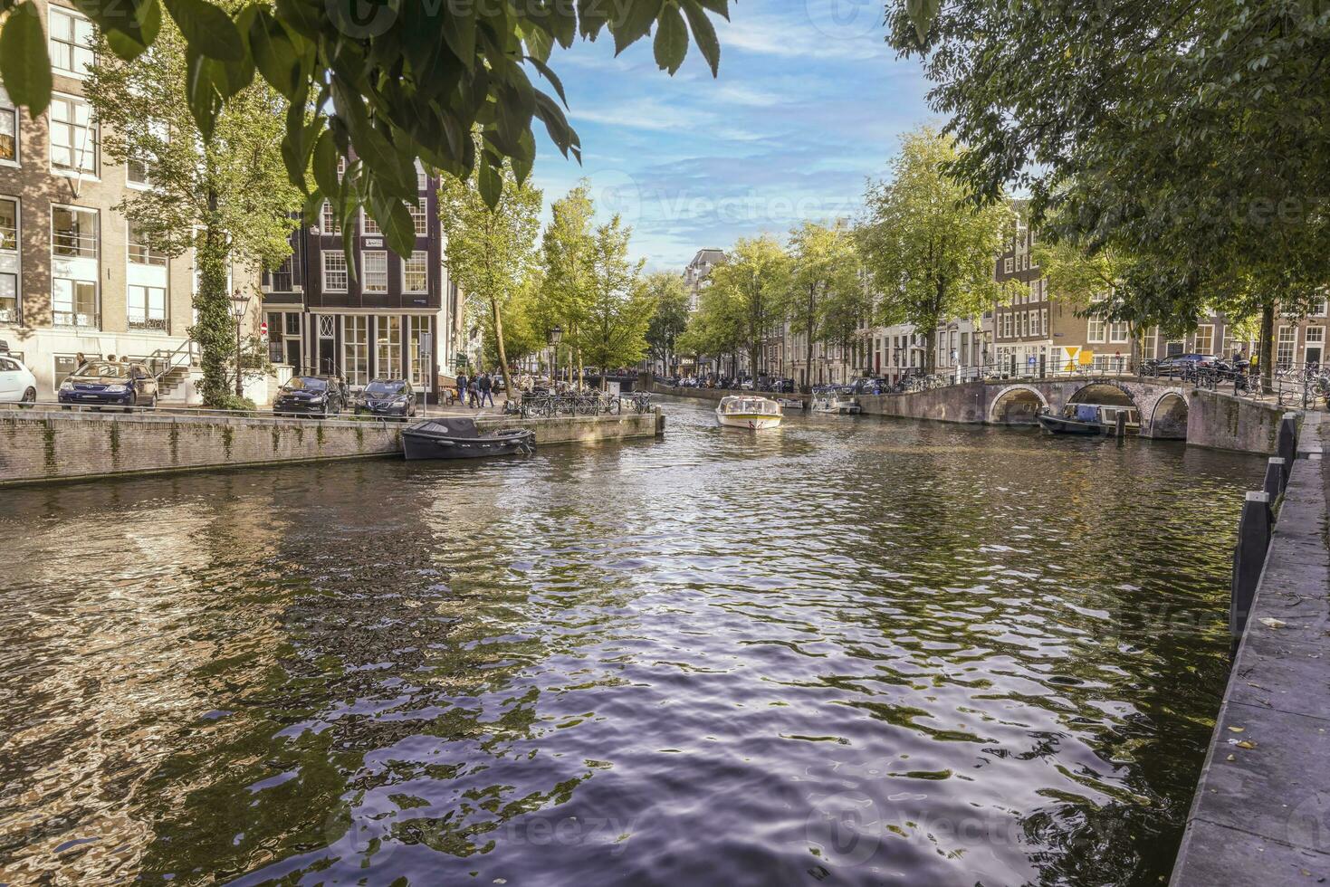 View over a typical canal in the Dutch metropolis Amsterdam in summer 2023 photo