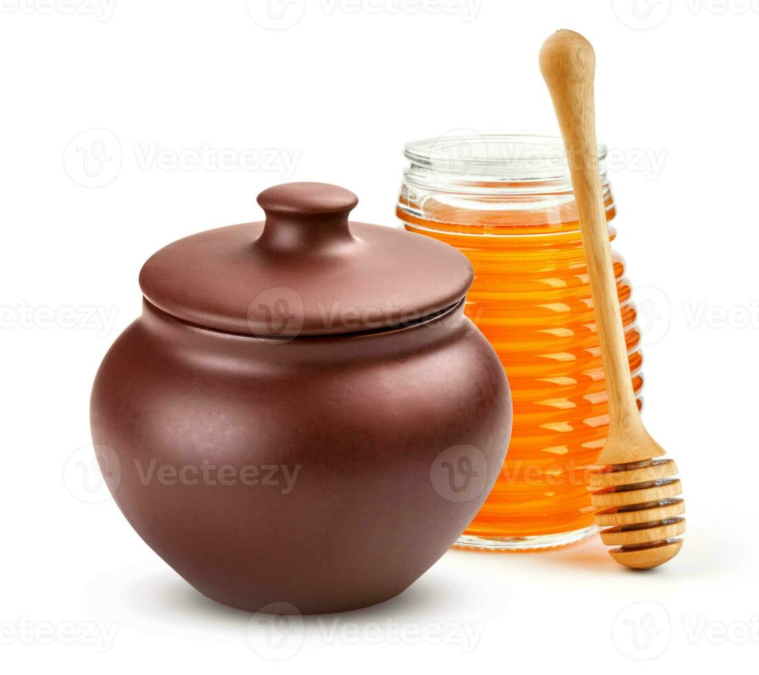 Honey pot and glass jar isolated on white photo