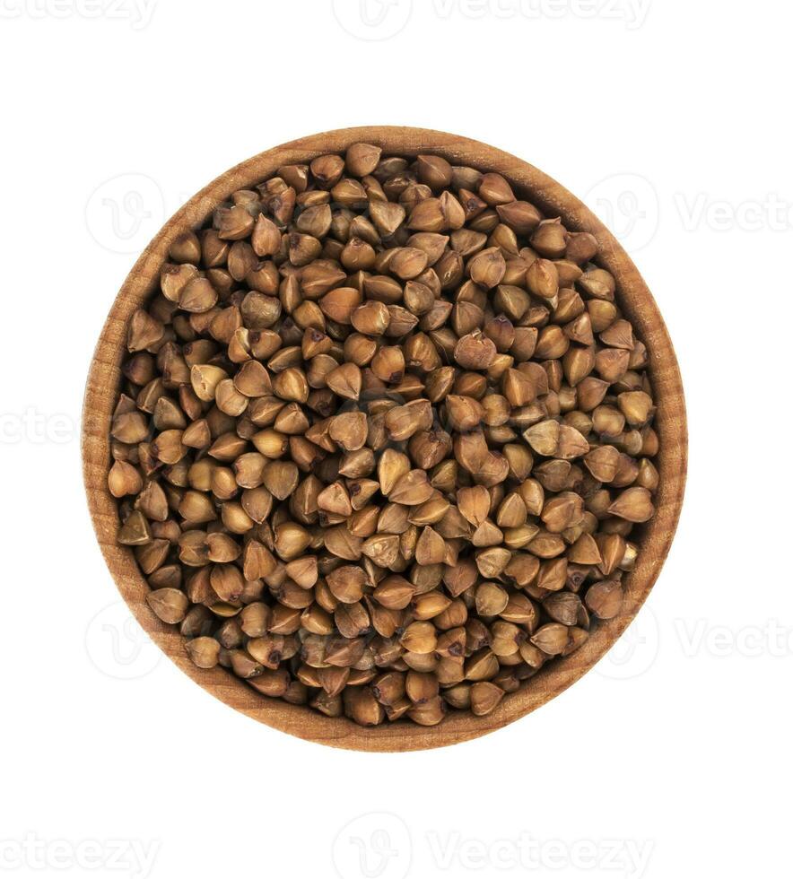 Buckwheat in wooden bowl isolated on white background. Top view photo