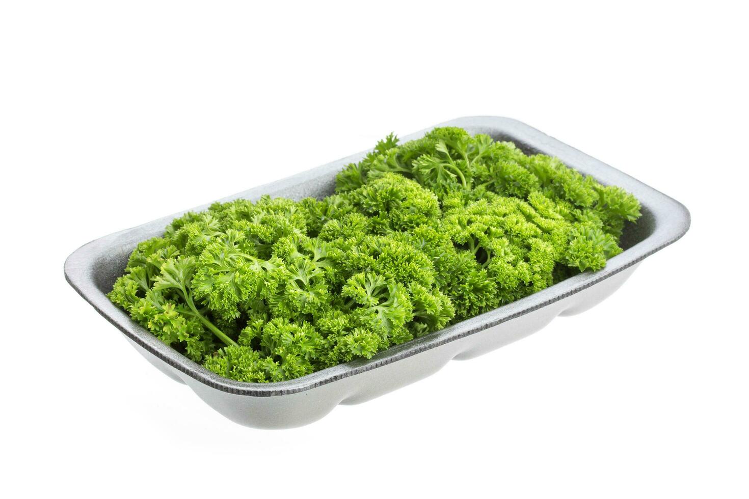 Parsley in plastic packaging, isolated on white photo