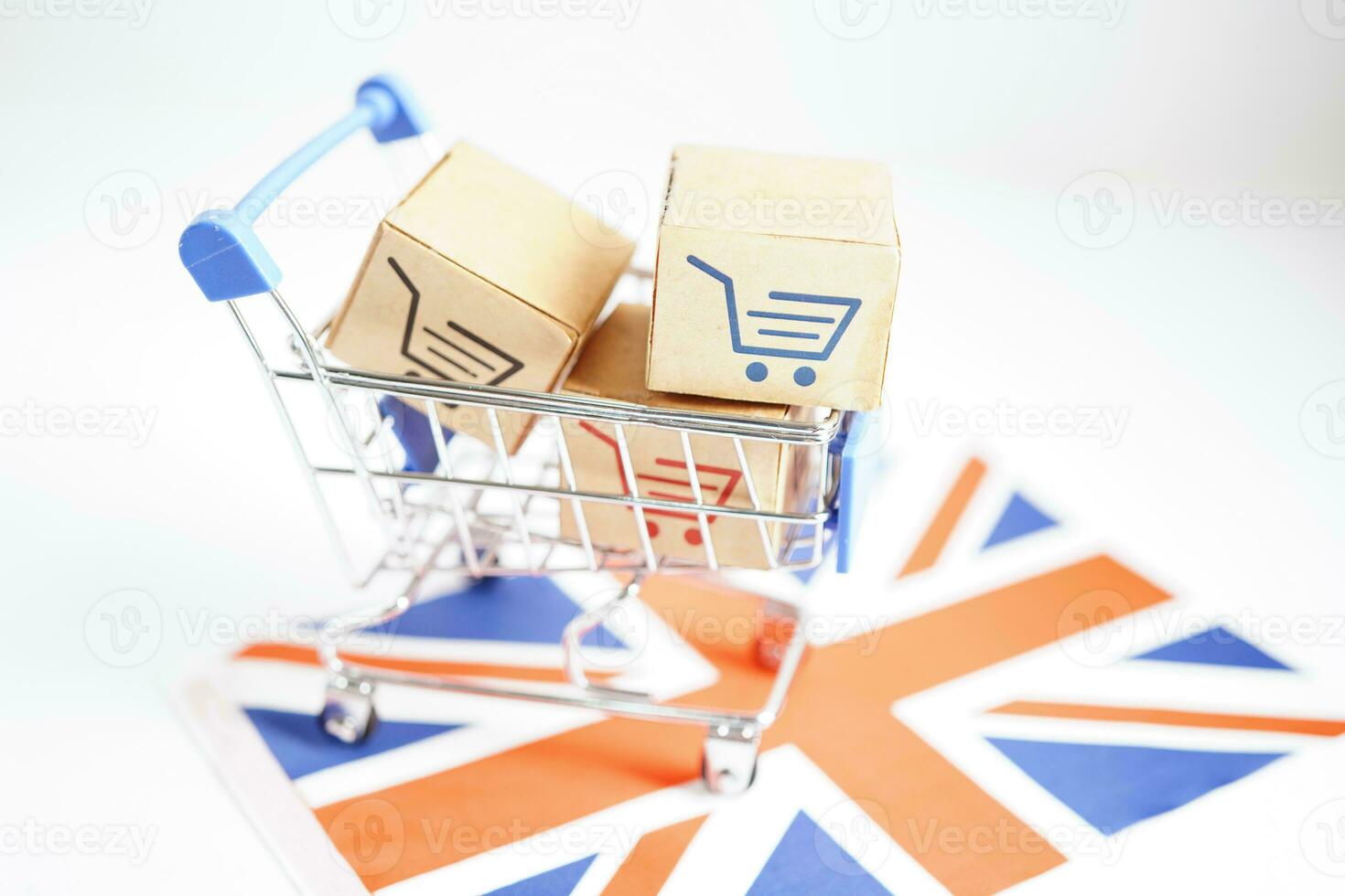 Online shopping, Shopping cart box on United Kingdom flag, import export, finance commerce. photo