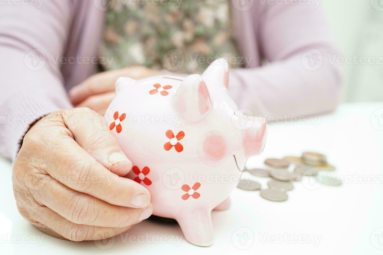 Retired elderly woman counting coins money with piggy bank and worry about monthly expenses and treatment fee payment. photo