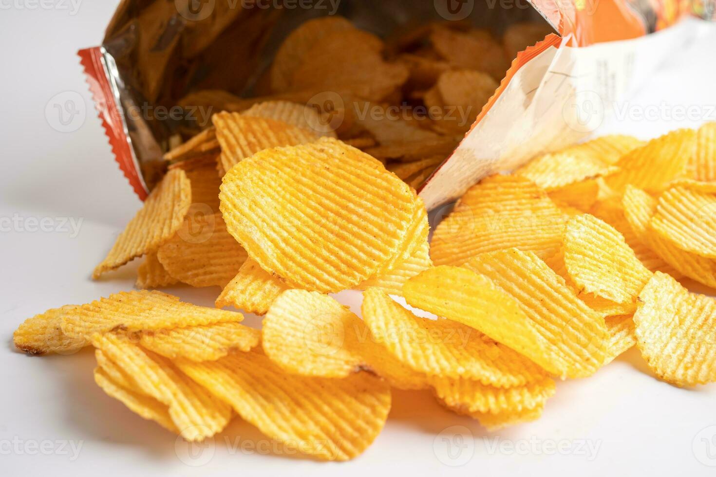 Potato chips, delicious BBQ seasoning spicy for crips, thin slice deep fried snack fast food in open bag. photo