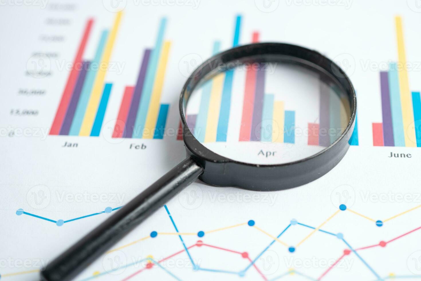 Magnifying glass on charts graphs paper. Financial development, Banking Account, Statistics, Investment Analytic research data economy. photo