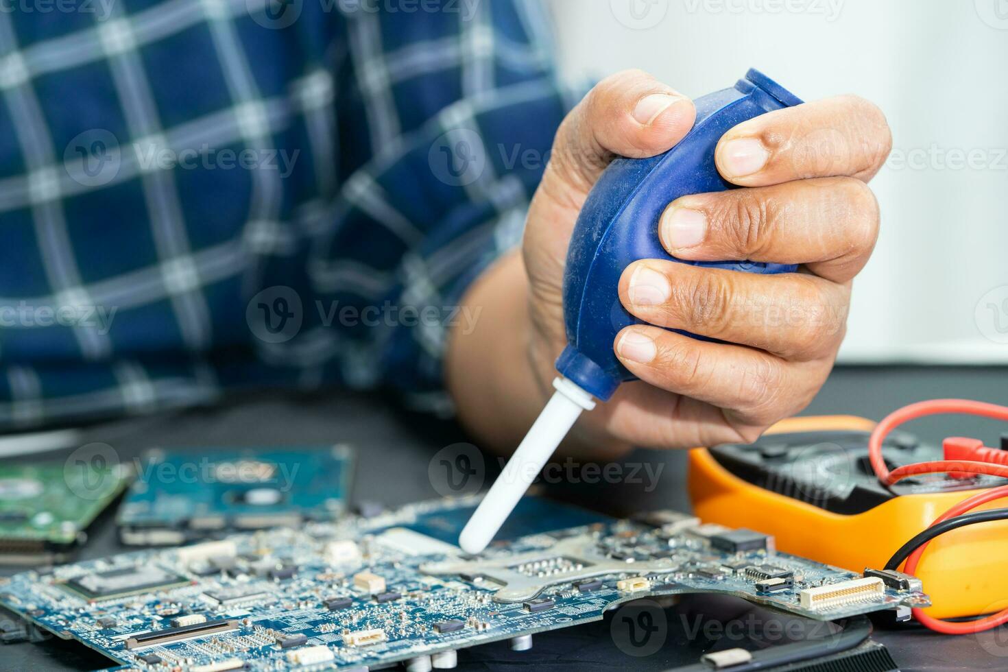 Asian technician repair and cleaning dirty micro circuit main board of smartphone electronic technology with brush, hardware, mobile phone, upgrade concept. photo