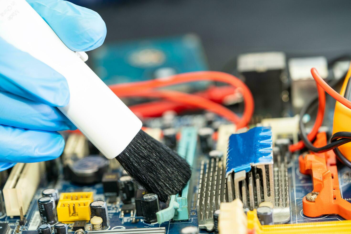 Asian technician repair and cleaning dirty micro circuit main board of smartphone electronic technology with brush, hardware, mobile phone, upgrade concept. photo