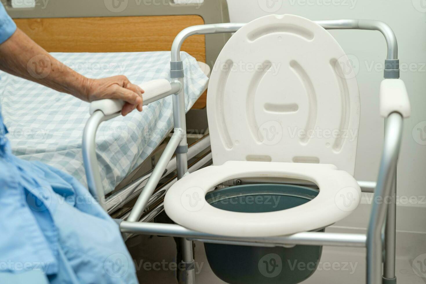 Flush toilet and shower chair in bathroom for old elder people. photo