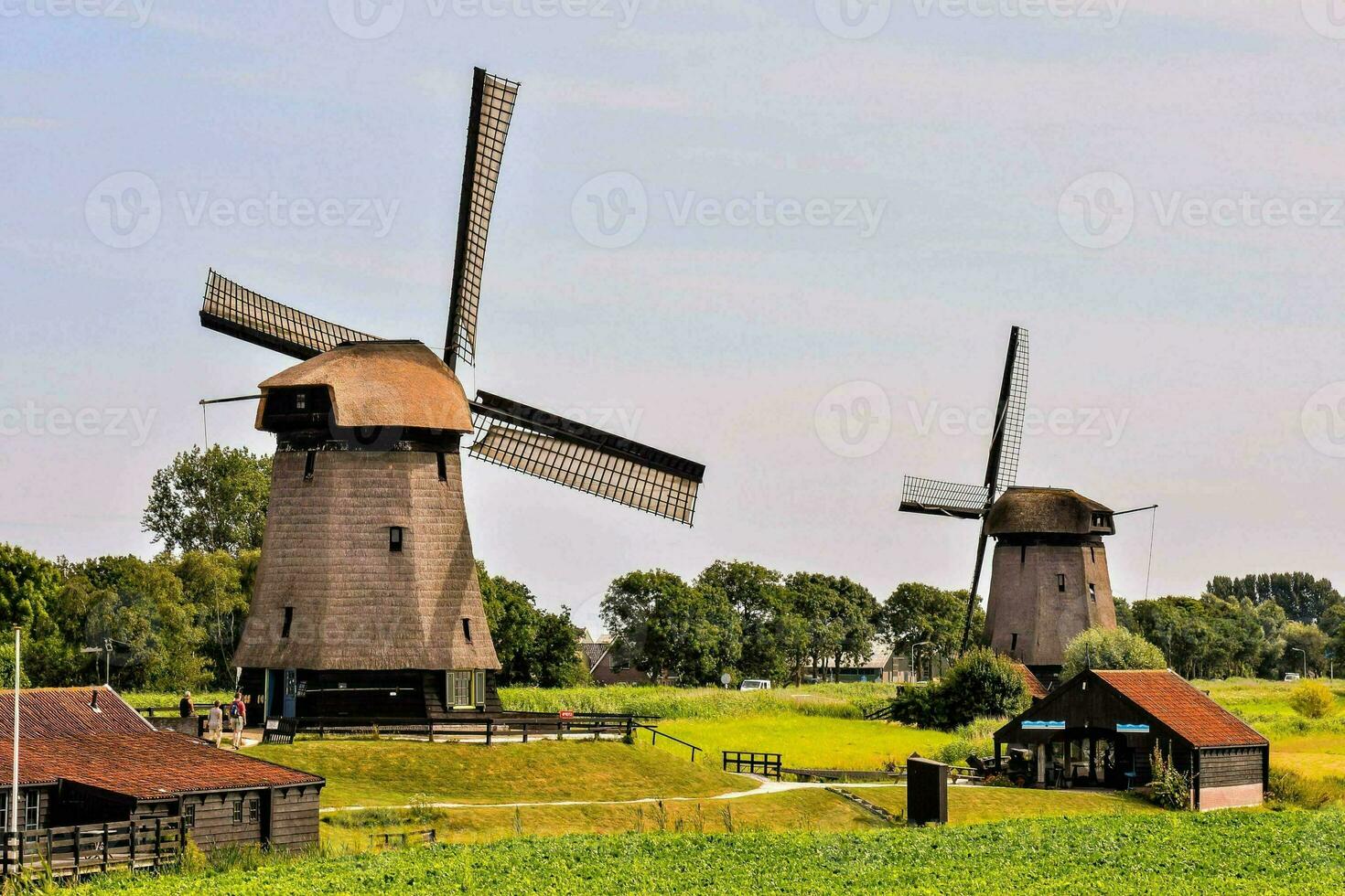 a windmill in the middle of a field photo