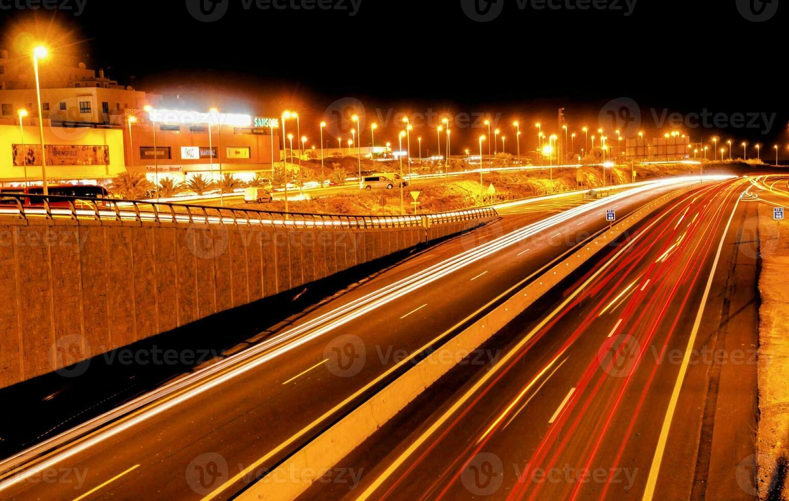 a highway at night with cars driving on it photo