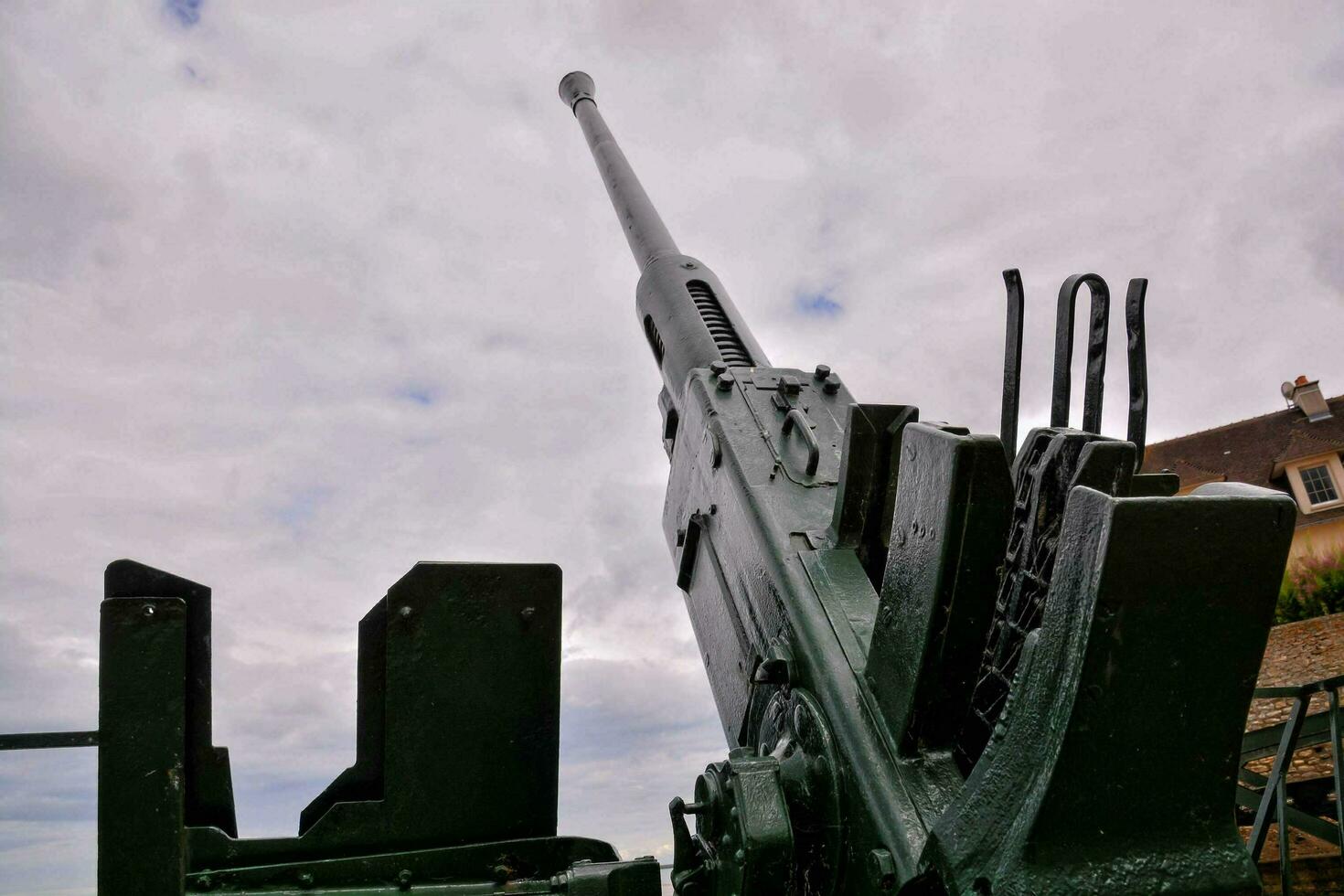 a large gun mounted on top of a building photo