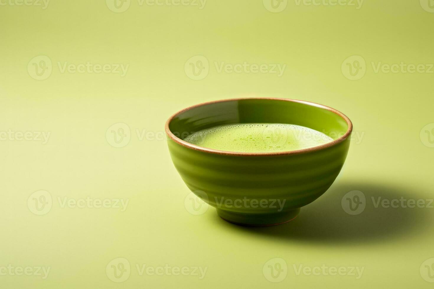 Matcha green tea in traditional bowl isolated on a gradient background photo