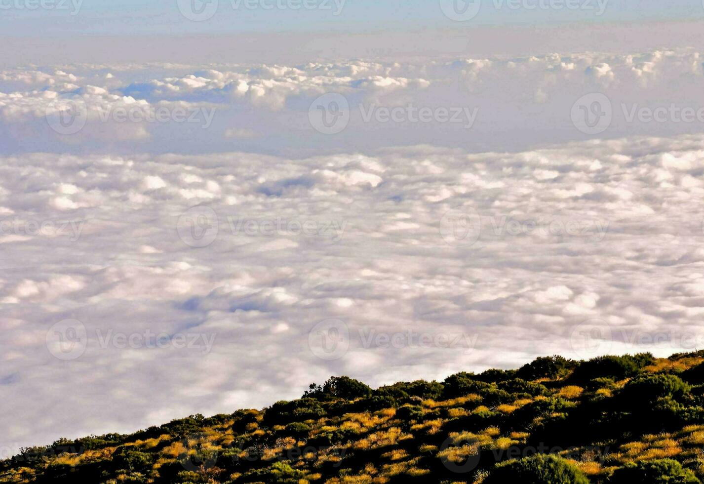 a view of the clouds from the top of a mountain photo