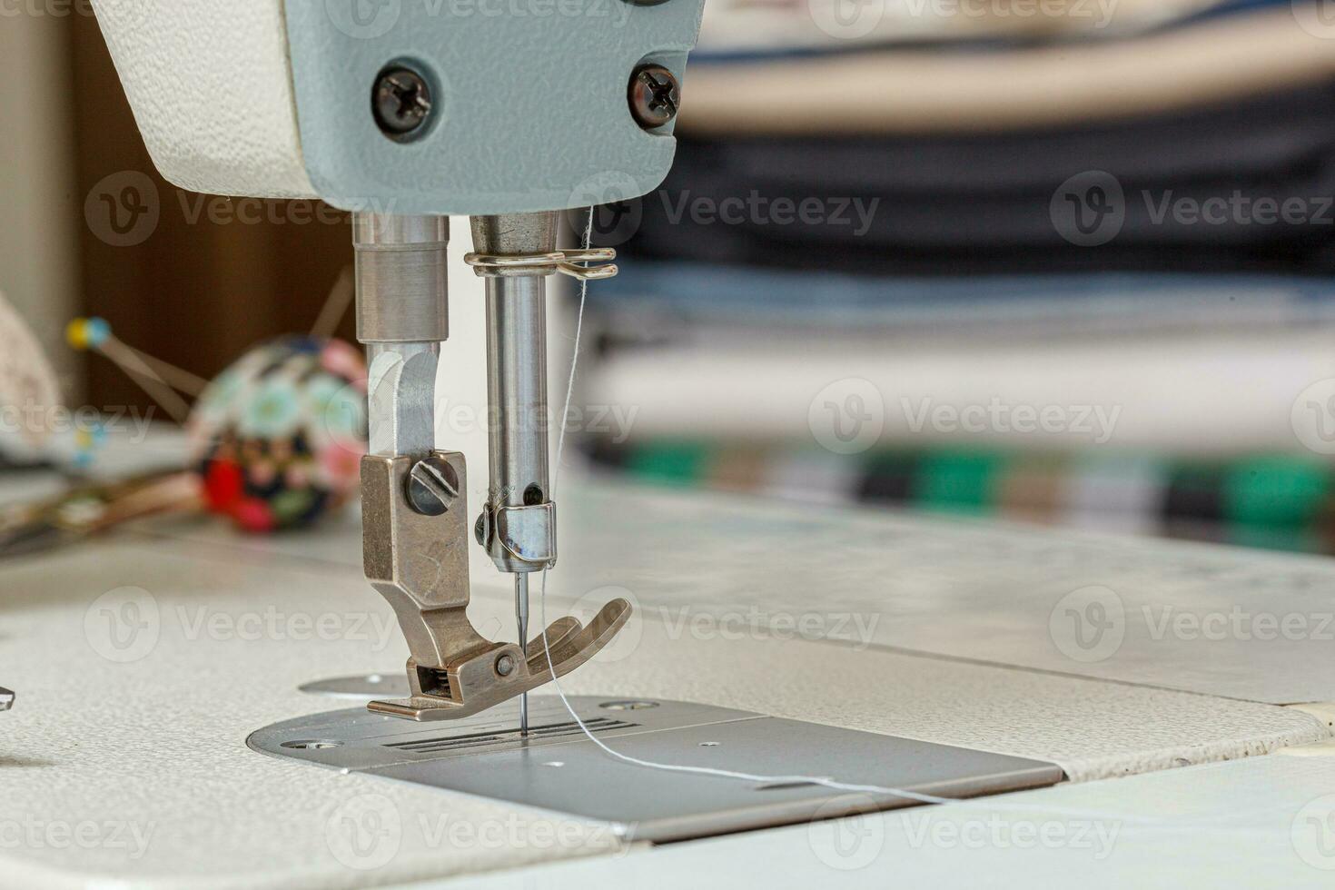 Sewing machine needle with thread and fabric photo