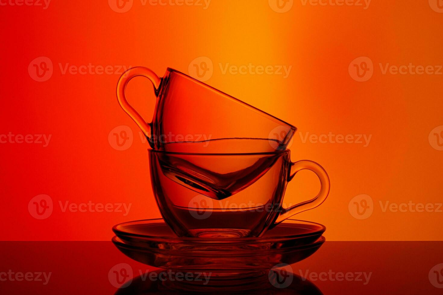 beautiful cups on red and orange background photo