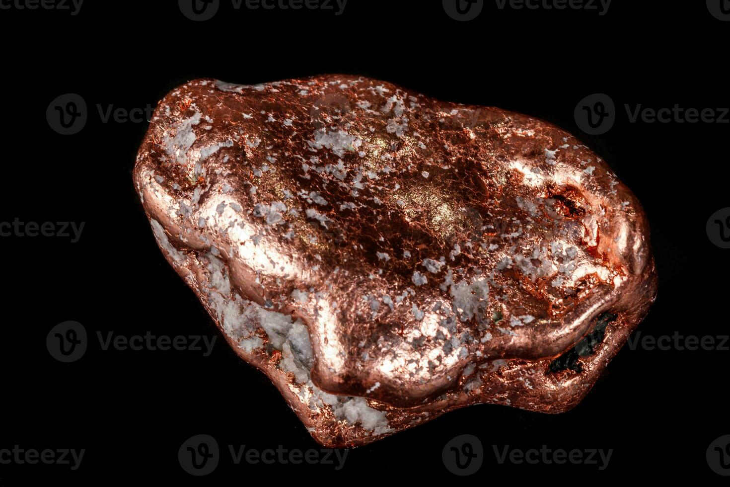 Macro mineral stone of a copper nugget on a microcline on a black background photo