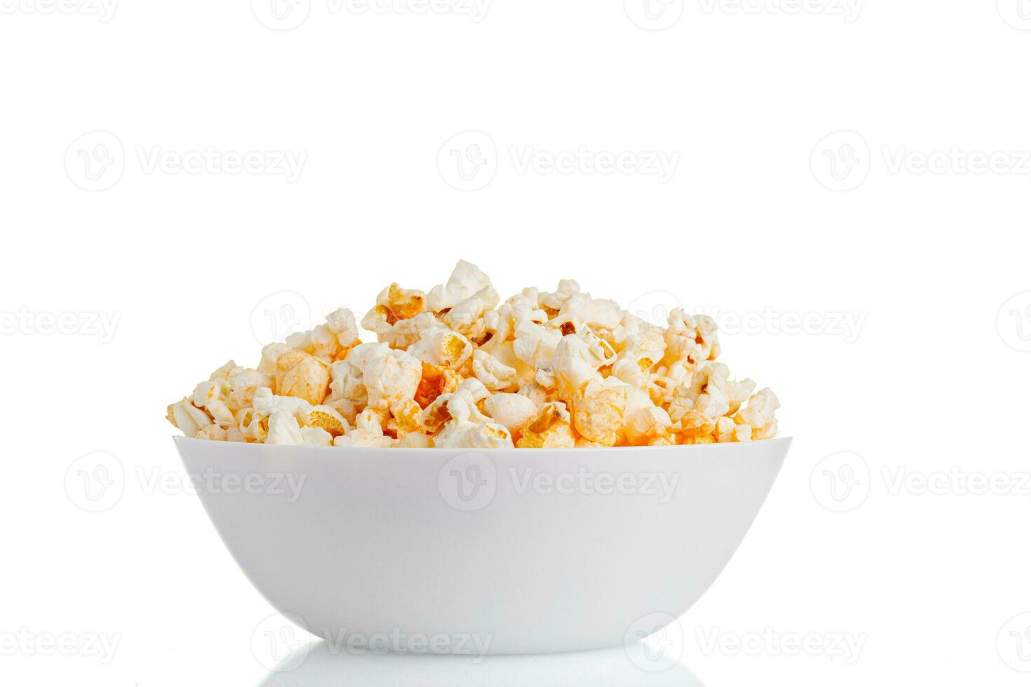 a plate of popcorn macro on a white background photo