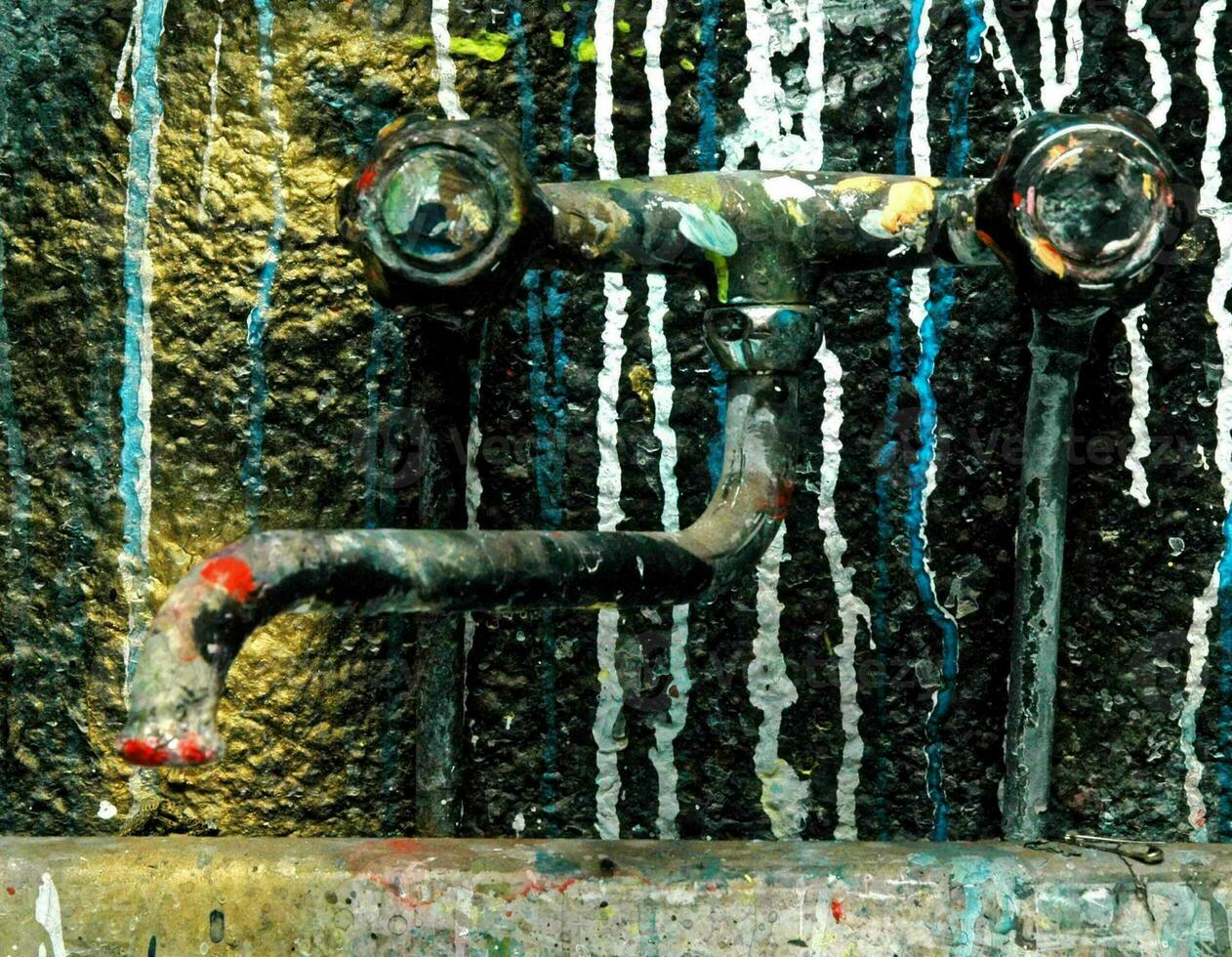 An old sink with paint dripping photo