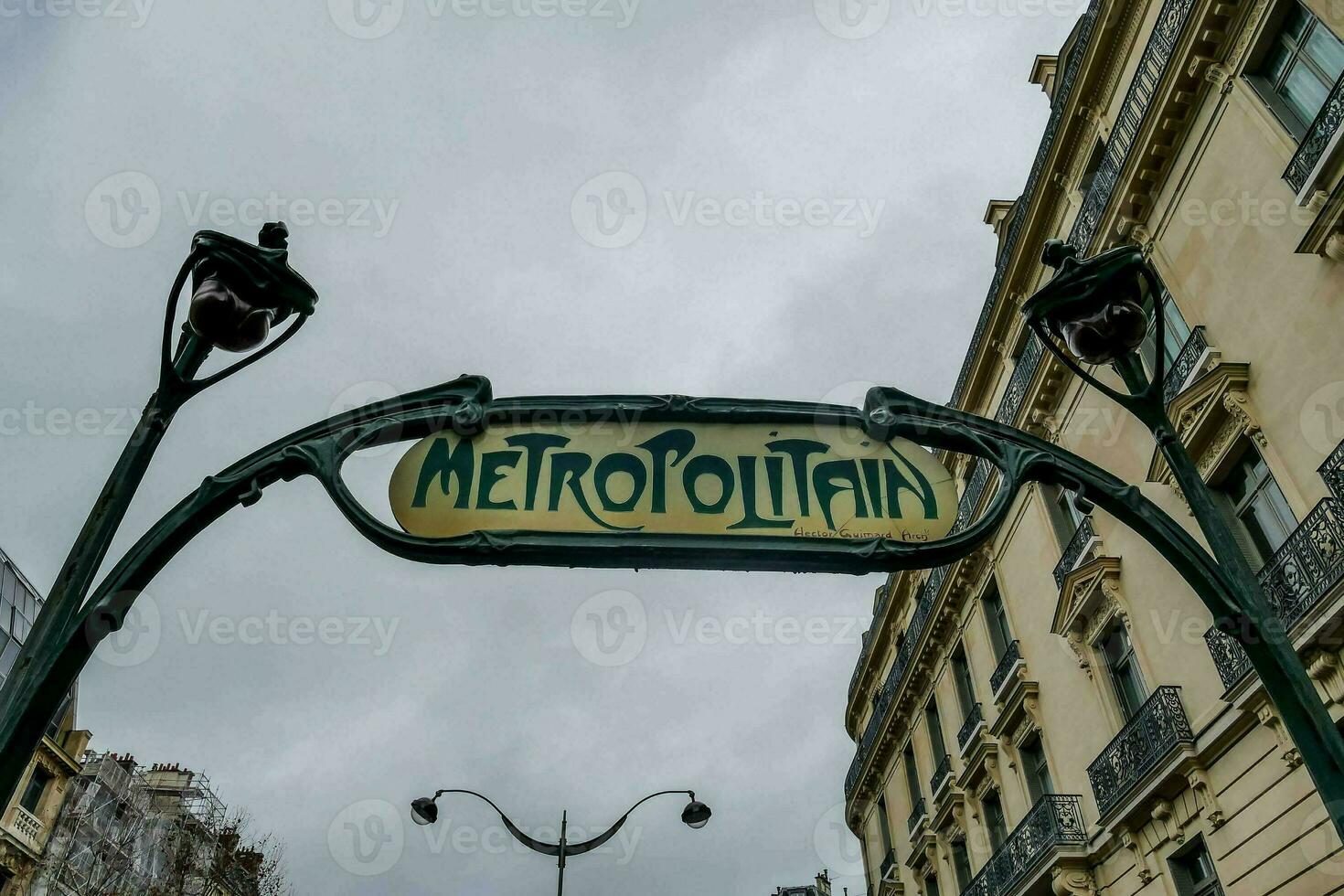 The metropolitan sign hanging between buildings in the city photo