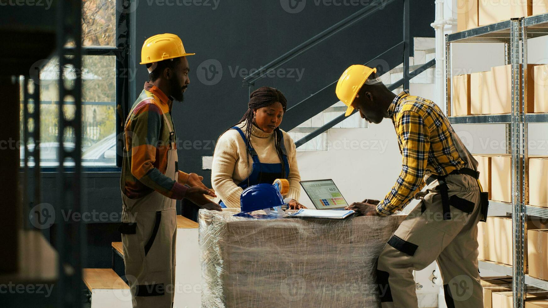 Manager catching employees wasting time in warehouse, team of people talking and laughing instead of packing products in boxes for distribution. Supervisor putting workers to do job. photo