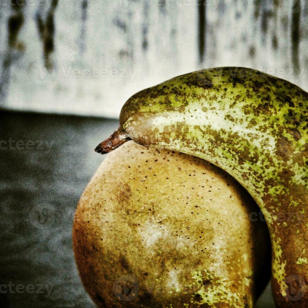 still life with pears on a wooden background photo