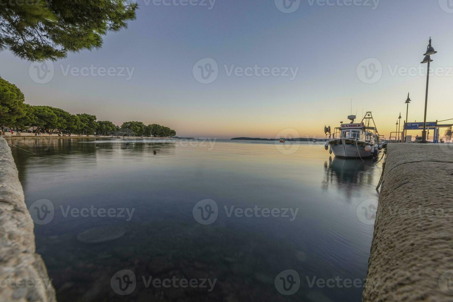 Picture over the harbor of Fazana in Istria in the evening during sunset photo