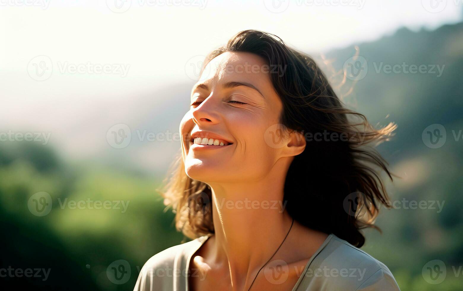 Middle age woman breathing fresh air in the mountains. photo