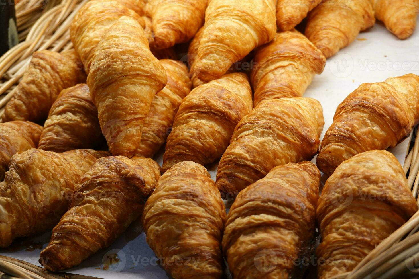Many croissants on on a black table in a bakery shop. photo