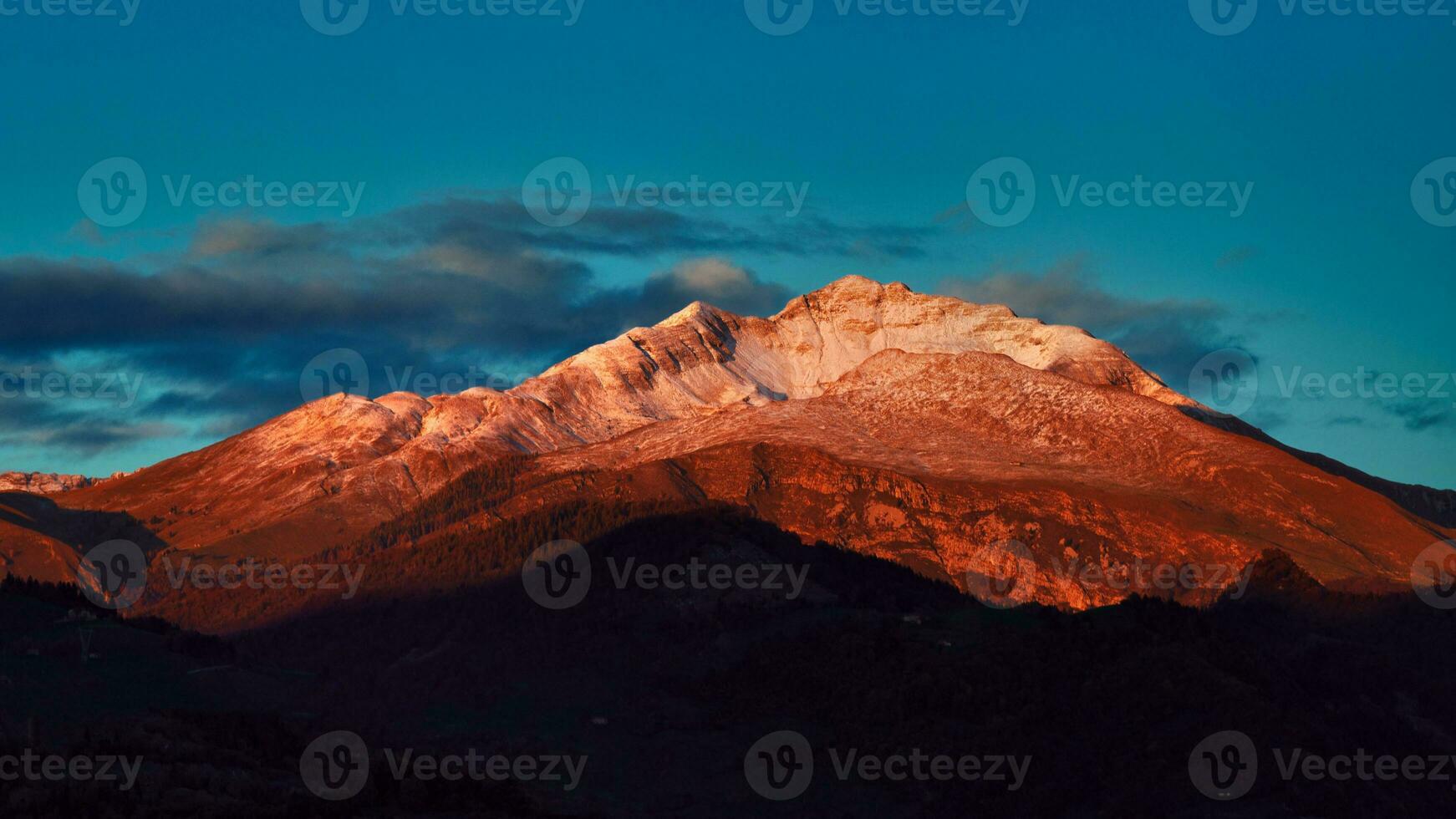 Mountain lit by the last sun of the day photo