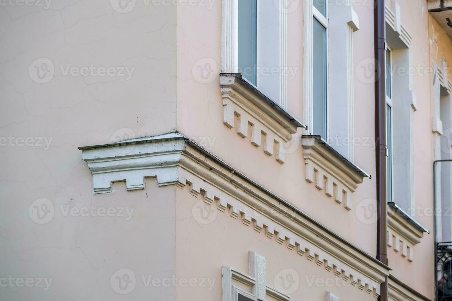 windows with decorative elements on an old wooden or brick building photo