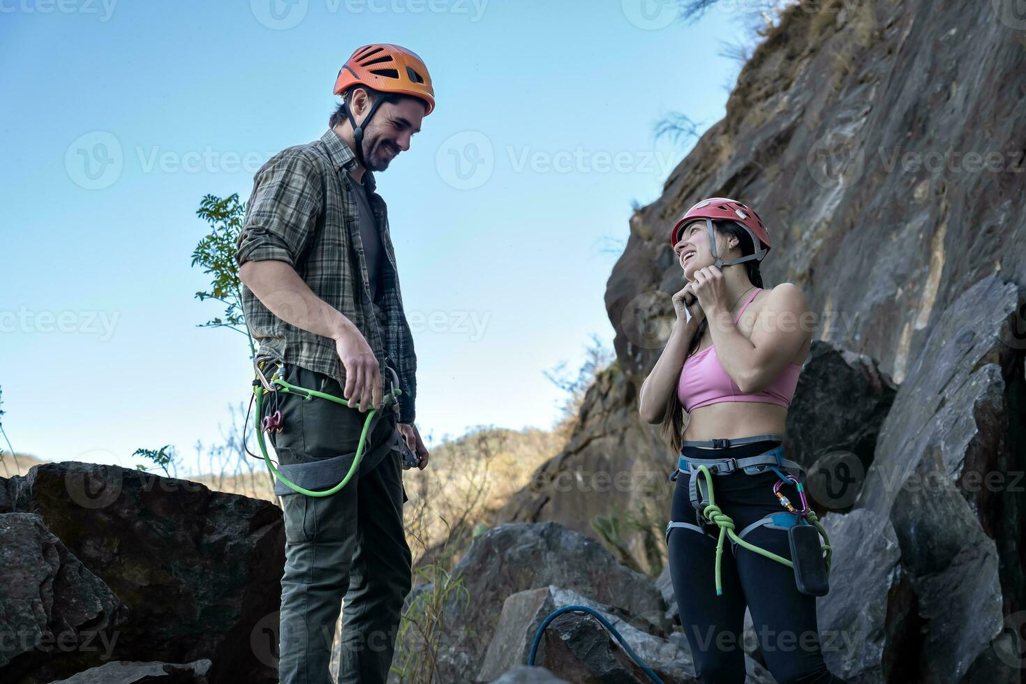 Young climbers standing preparing climbing equipment. photo