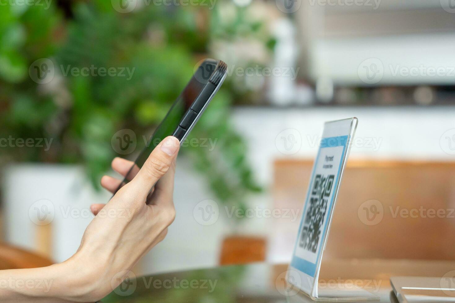 Woman use smartphone to scan QR code to pay in cafe restaurant with a digital payment without cash. Choose menu and order accumulate discount. E wallet, technology, pay online, credit card, bank app. photo