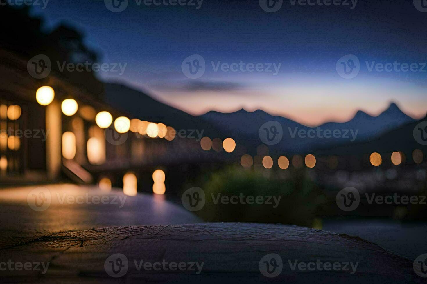 a view of the mountains at night with lights on the ground. AI-Generated photo