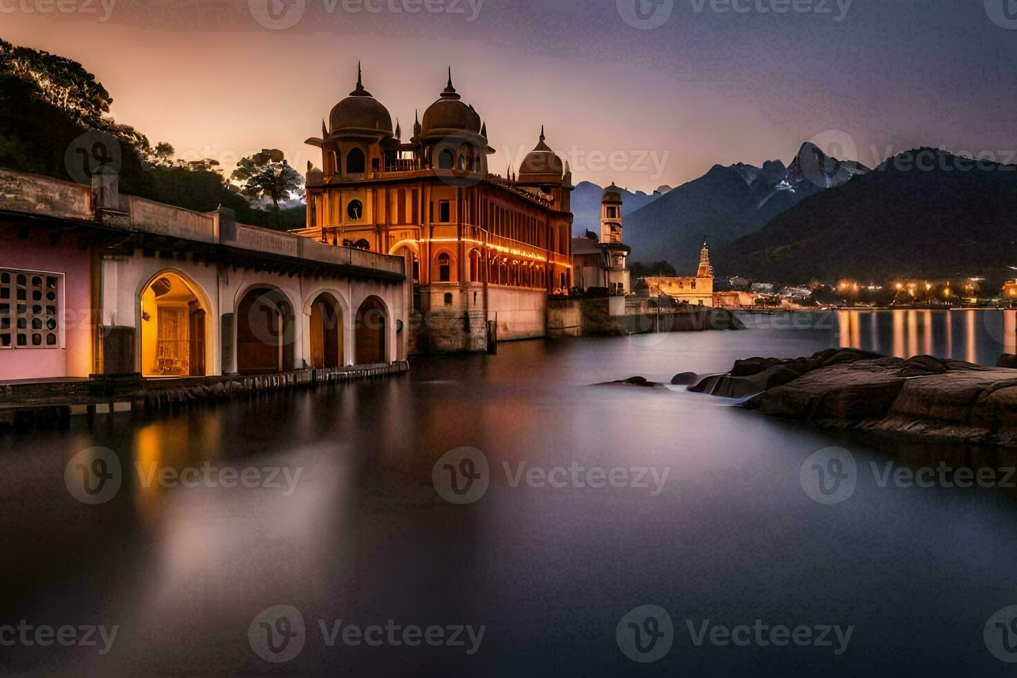 a beautiful building sits on the water in front of mountains. AI-Generated photo
