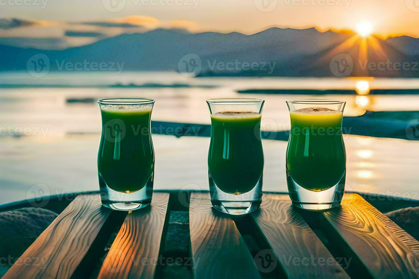 three glasses of green juice sit on a table in front of the sunset. AI-Generated photo